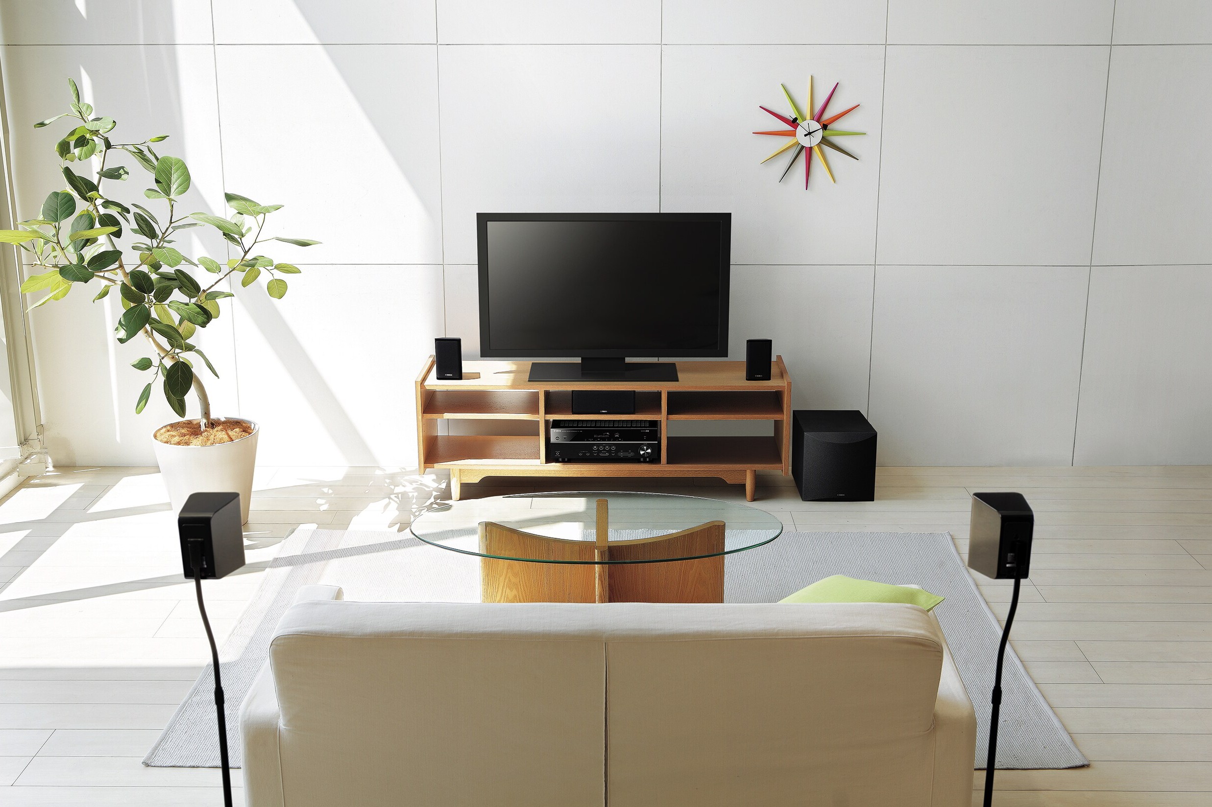 Yamaha 5.1 home cinema package set up in a bright living room around a television
